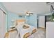 Bright bedroom features a rattan bed frame, modern ceiling fan, and contemporary decor for a relaxing atmosphere at 6560 5Th S Ave, St Petersburg, FL 33707