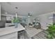 Bright living room features an open floor plan, modern gray sofa, and updated kitchen and dining areas at 6560 5Th S Ave, St Petersburg, FL 33707