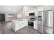 Open kitchen featuring white cabinets, quartz counters, stainless steel appliances, and tile flooring at 10108 Hunters Point Ct, Tampa, FL 33615