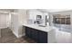 Modern kitchen featuring white cabinets, a gray island with a white countertop, and stainless steel appliances at 10108 Hunters Point Ct, Tampa, FL 33615