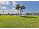 Picturesque waterfront view with picnic tables and palm trees offering a serene spot to enjoy the surroundings at 1028 Apollo Beach Blvd # 13, Apollo Beach, FL 33572