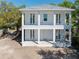 Striking two-story white home features a double porch and an inviting exterior design at 1119 26Th N Ave, St Petersburg, FL 33704