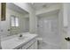 Bathroom featuring a vanity, toilet, mirror, and shower over tub combo with white tiles at 1370 70Th N St # 2-1382, St Petersburg, FL 33710