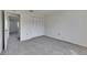 Neutral bedroom with plush carpeting and closet with white folding doors at 1370 70Th N St # 2-1382, St Petersburg, FL 33710