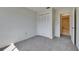 Bedroom featuring carpet flooring, closet, and a bright bathroom entrance at 1370 70Th N St # 2-1382, St Petersburg, FL 33710