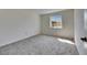 Bright bedroom featuring neutral walls, plush carpeting, and a window providing natural light at 1370 70Th N St # 2-1382, St Petersburg, FL 33710