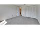 Neutral bedroom with plush carpeting and closet with white folding doors with hall entrance at 1370 70Th N St # 2-1382, St Petersburg, FL 33710