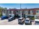 Exterior shot of the townhome featuring designated parking, mature landscaping, and freshly painted facade at 1370 70Th N St # 2-1382, St Petersburg, FL 33710