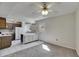 Open-concept kitchen featuring white tile floors, island seating and modern appliances at 1370 70Th N St # 2-1382, St Petersburg, FL 33710