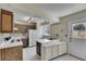 Well-lit kitchen with white cabinets, tile flooring, and modern appliances at 1370 70Th N St # 2-1382, St Petersburg, FL 33710
