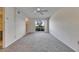 Spacious living room with neutral carpet, ceiling fan, and a bright window at 1370 70Th N St # 2-1382, St Petersburg, FL 33710