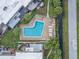 Aerial view of a community pool surrounded by lounge chairs and palm trees at 1370 70Th N St # 2-1382, St Petersburg, FL 33710