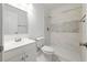 Bathroom featuring a shower with marble-like tiles and a single sink vanity at 16109 Northglenn Dr, Tampa, FL 33618