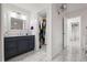 Bathroom vanity with a vessel sink, decorative mirror, and a closet for storage with white marble floors at 16109 Northglenn Dr, Tampa, FL 33618