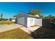 Garage and fenced side yard of light gray single-story home on a sunny day at 16109 Northglenn Dr, Tampa, FL 33618
