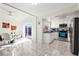 Bright kitchen with stainless steel appliances, white cabinets, and a dining area with sliding glass doors at 16109 Northglenn Dr, Tampa, FL 33618