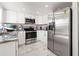 Modern kitchen featuring stainless steel appliances, granite countertops, and white cabinets at 16109 Northglenn Dr, Tampa, FL 33618