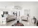 Open-concept living room with marble floors, modern furniture, and abundant natural light at 16109 Northglenn Dr, Tampa, FL 33618