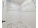 A walk-in closet with wire shelving and marble tile flooring at 16109 Northglenn Dr, Tampa, FL 33618