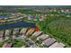 Home near a lake and surrounded by lush greenery and other neighborhood homes at 16135 Cape Coral Dr, Wimauma, FL 33598