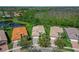 Aerial shot of home surrounded by palm trees and green landscaping at 16135 Cape Coral Dr, Wimauma, FL 33598