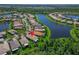 Beautiful lake view home surrounded by lush greenery and manicured lawns at 16135 Cape Coral Dr, Wimauma, FL 33598