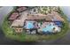 Overhead view of the community clubhouse, featuring pools, tennis courts, and manicured grounds at 16135 Cape Coral Dr, Wimauma, FL 33598