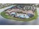 Aerial shot of a community clubhouse with pools, tennis courts, and beautiful landscaping at 16135 Cape Coral Dr, Wimauma, FL 33598