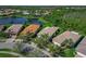 Aerial view of home with palm trees, nearby lakes, and well-maintained landscaping at 16135 Cape Coral Dr, Wimauma, FL 33598