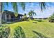 Expansive backyard with lush landscaping and serene water views, perfect for outdoor enjoyment and relaxation at 16135 Cape Coral Dr, Wimauma, FL 33598