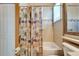 Bathroom showcasing a neutral shower curtain and tub in earth tone tiling at 16135 Cape Coral Dr, Wimauma, FL 33598