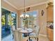 Charming breakfast nook featuring a round table with seating for four and a view to the lanai at 16135 Cape Coral Dr, Wimauma, FL 33598