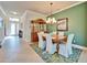 Dining room features a decorative green wall, a large hutch, and seating for six at 16135 Cape Coral Dr, Wimauma, FL 33598