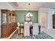 Dining room with a large hutch, seating for six, and a decorative green wall at 16135 Cape Coral Dr, Wimauma, FL 33598