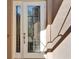 Elegant front door with decorative glass panels and a sidelight, allowing natural light into the home at 16135 Cape Coral Dr, Wimauma, FL 33598