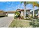 Charming single-story home with well-manicured landscaping and a brick driveway at 16135 Cape Coral Dr, Wimauma, FL 33598