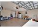 Clean garage with epoxy flooring, storage shelves, and access door to the interior of the home at 16135 Cape Coral Dr, Wimauma, FL 33598