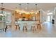 Bright kitchen with custom cabinets, granite countertops, stainless appliances, and a breakfast bar at 16135 Cape Coral Dr, Wimauma, FL 33598