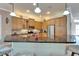 Lovely kitchen with granite countertops, stainless steel appliances, a breakfast bar, and pendant lighting at 16135 Cape Coral Dr, Wimauma, FL 33598