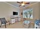 Inviting office space featuring a built-in desk, a comfortable chair, and a large window with shutters at 16135 Cape Coral Dr, Wimauma, FL 33598