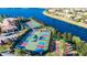Aerial view showing vibrant pickleball and shuffleboard courts located within the community at 16135 Cape Coral Dr, Wimauma, FL 33598