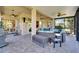 Inviting screened lanai featuring comfortable seating, dual ceiling fans, and an idyllic outdoor living space at 16135 Cape Coral Dr, Wimauma, FL 33598
