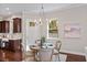 Bright dining area with hardwood floors, chandelier, and view of the modern kitchen at 2614 W Horatio St # 1, Tampa, FL 33609