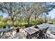 An outdoor patio area featuring pavers, surrounded by lush landscaping and providing an ideal spot for relaxation and entertaining at 2903 Marble Crest Dr, Land O Lakes, FL 34638