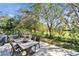 A back patio featuring a dining set, with lush greenery, providing an ideal spot for relaxation and entertaining at 2903 Marble Crest Dr, Land O Lakes, FL 34638