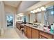 En suite bathroom with double sinks, soaking tub, vanity and walk-in closet at 2903 Marble Crest Dr, Land O Lakes, FL 34638