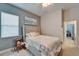 Comfortable bedroom featuring a large bed, artwork, and a window for plenty of natural light at 2903 Marble Crest Dr, Land O Lakes, FL 34638