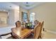 Formal dining room with ornate table, seating for six, and arched window at 2903 Marble Crest Dr, Land O Lakes, FL 34638