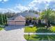 Charming single-story home featuring a three-car garage, lush landscaping, and a well-manicured lawn at 2903 Marble Crest Dr, Land O Lakes, FL 34638
