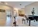 View of the foyer featuring open floorplan with dining room and den/office space, with beige tile flooring at 2903 Marble Crest Dr, Land O Lakes, FL 34638